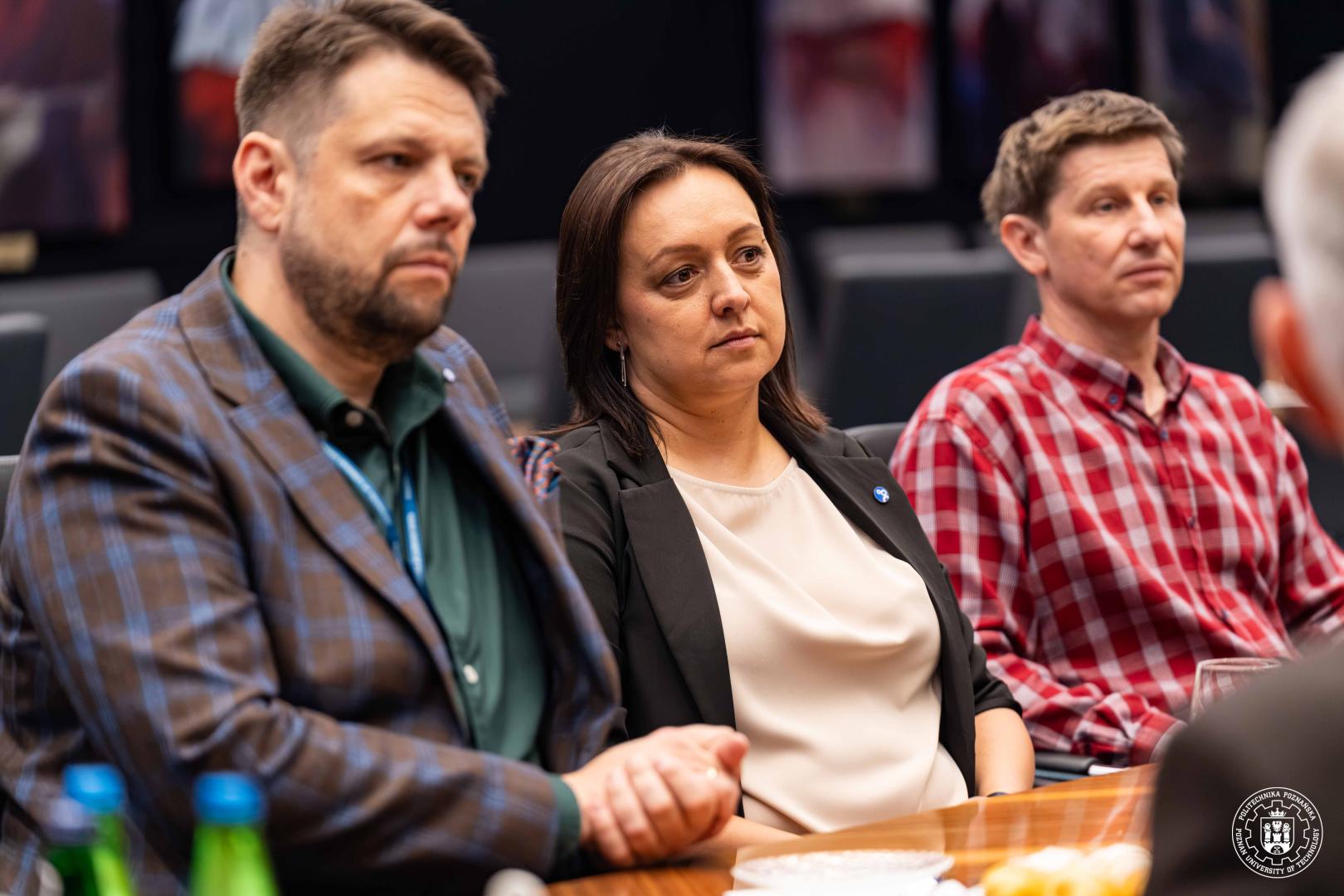 Uczestnicy spotkania rozmawiają przy stole konferencyjnym podczas rozmów Politechniki Poznańskiej z RECARO.