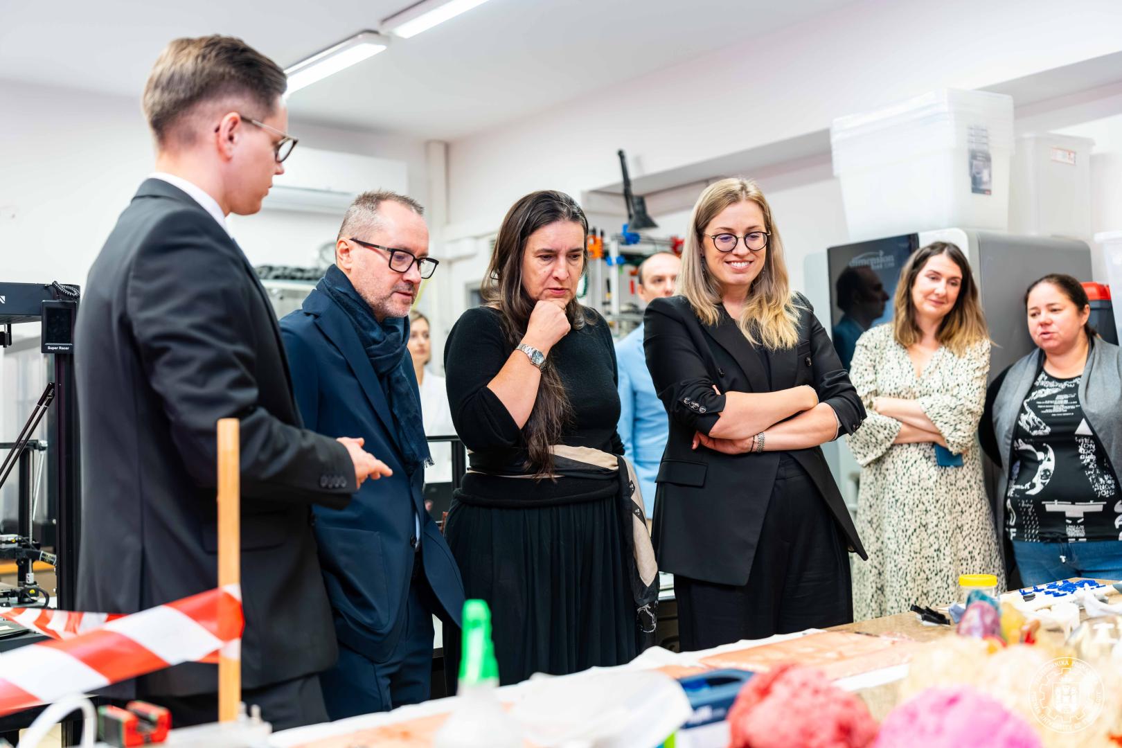 Uczestnicy spotkania inauguracyjnego oglądający prezentację sprzętu w Laboratorium Wytwarzania Przyrostowego Politechniki Poznańskiej.